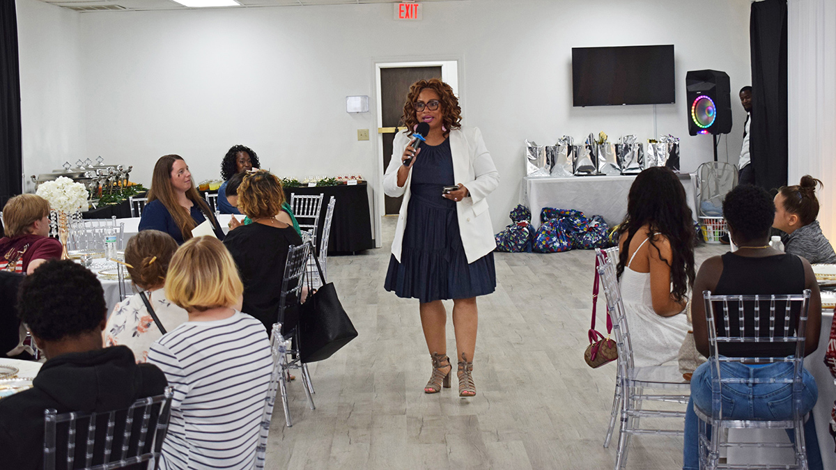 Life Coach Sima Clark speaks at a celebration of graduating foster teens in the LINKS program